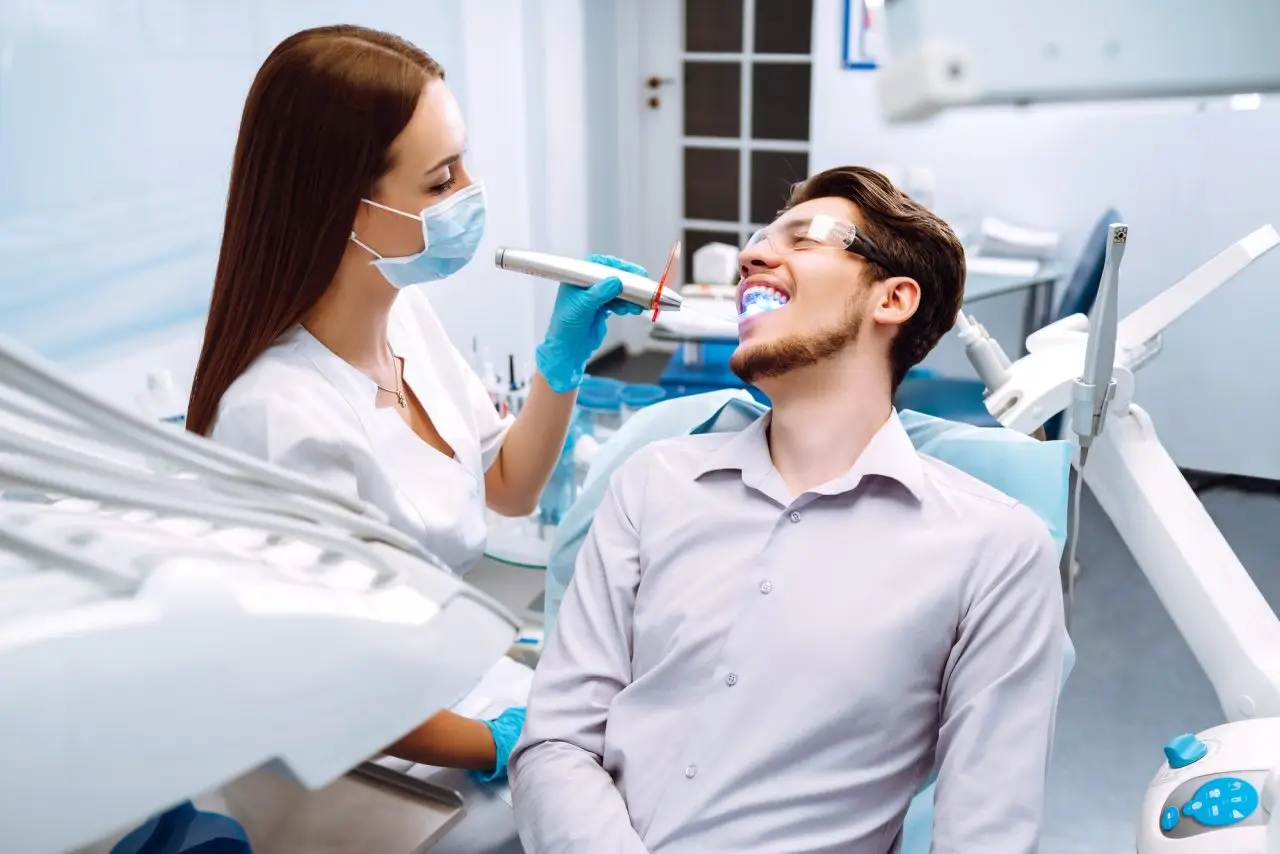 Dentist performing teeth whitening