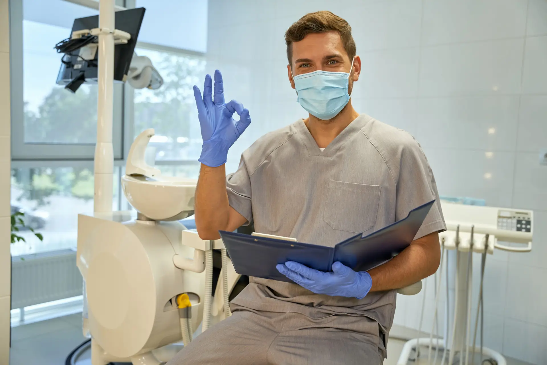 Dentist giving okay gesture in clinic