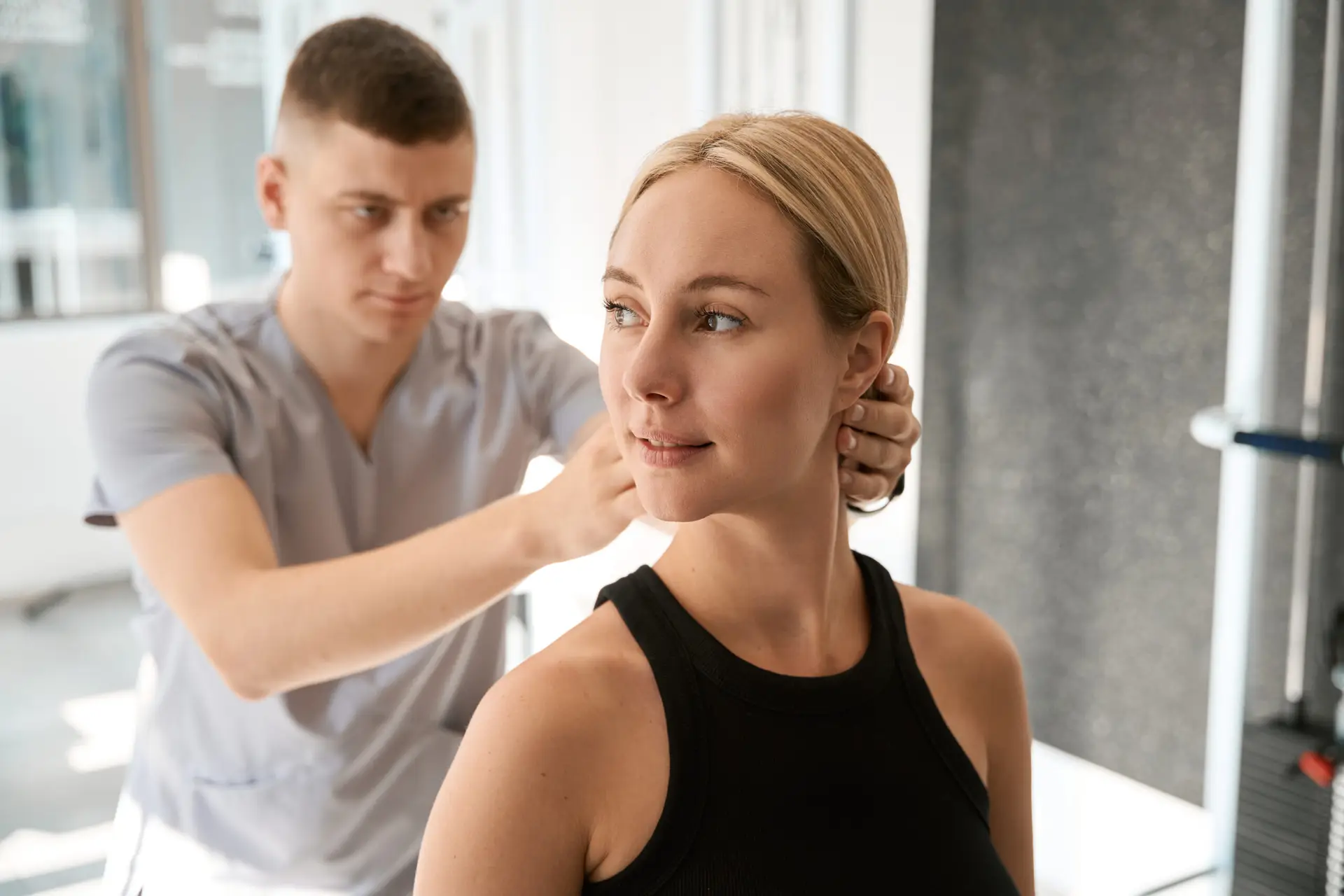Chiropractor adjusting client's neck